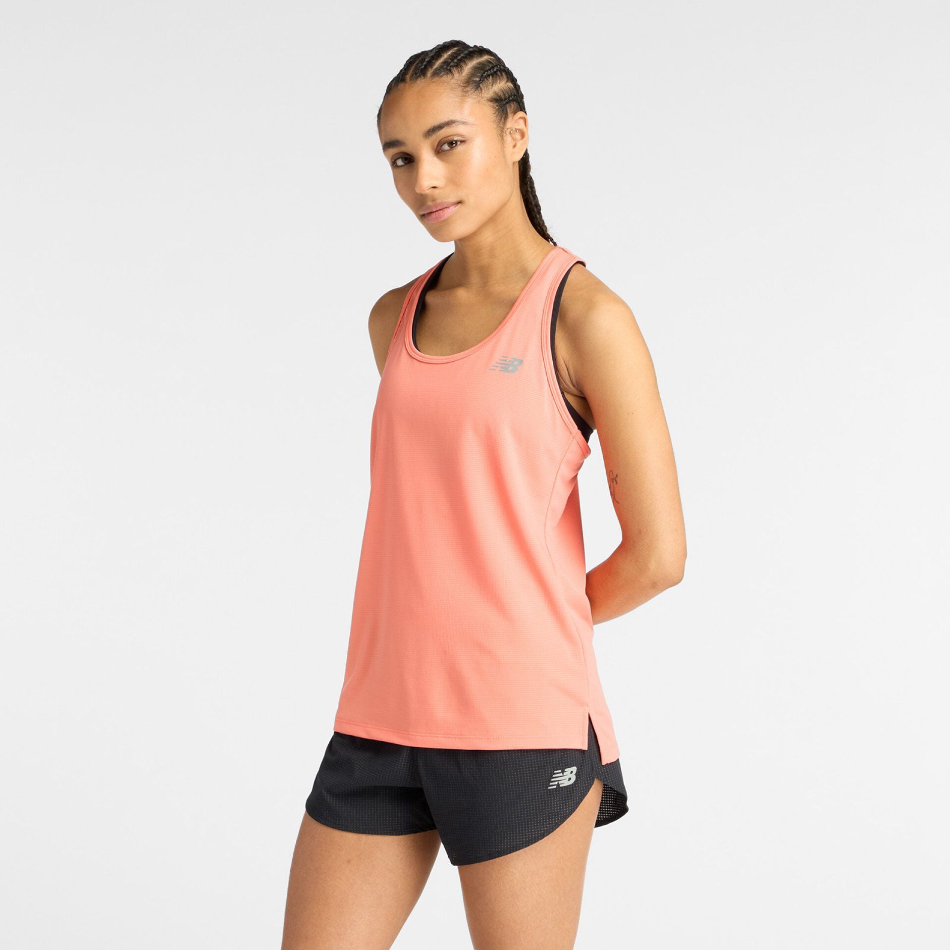 Woman in tank top and shorts.