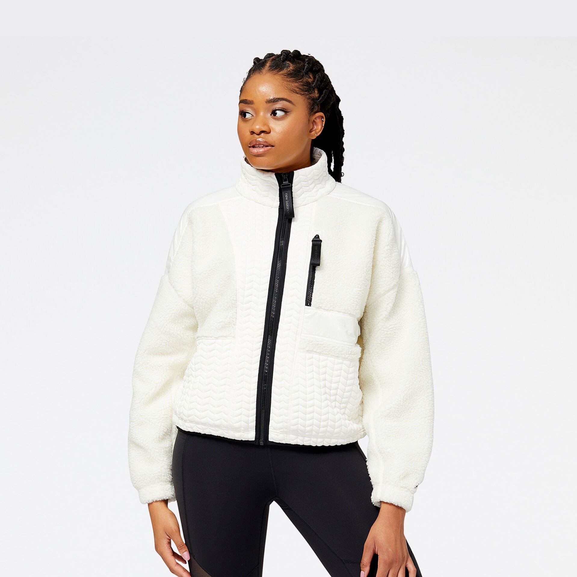 Woman in New Balance fleece white jacket.