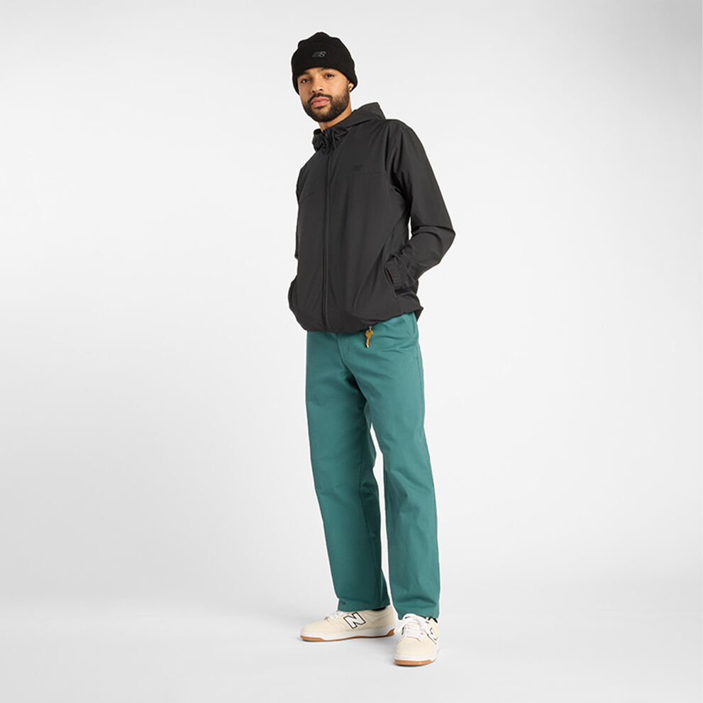 Man in black jacket and green pants.