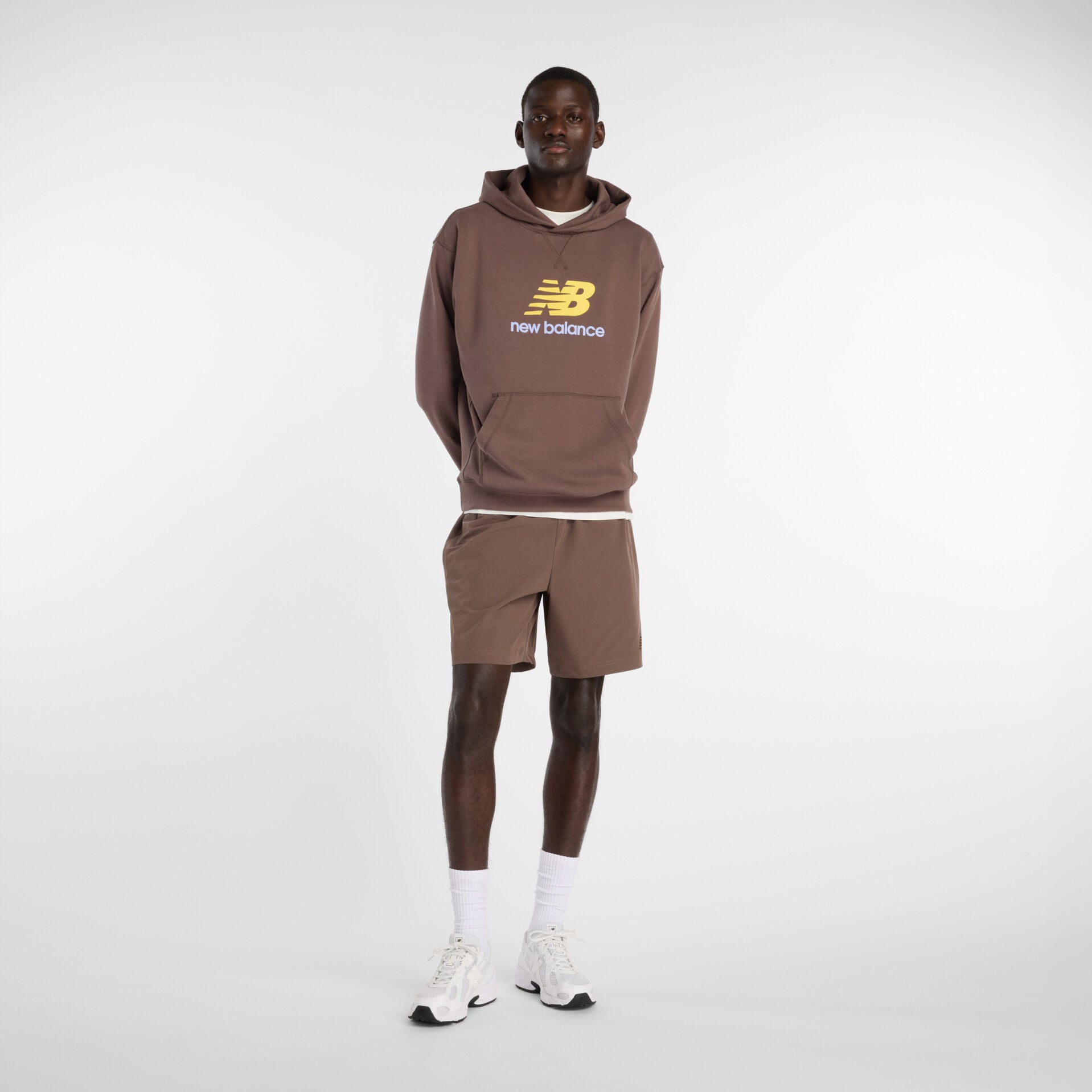 Man in brown sweatshirt and shorts.